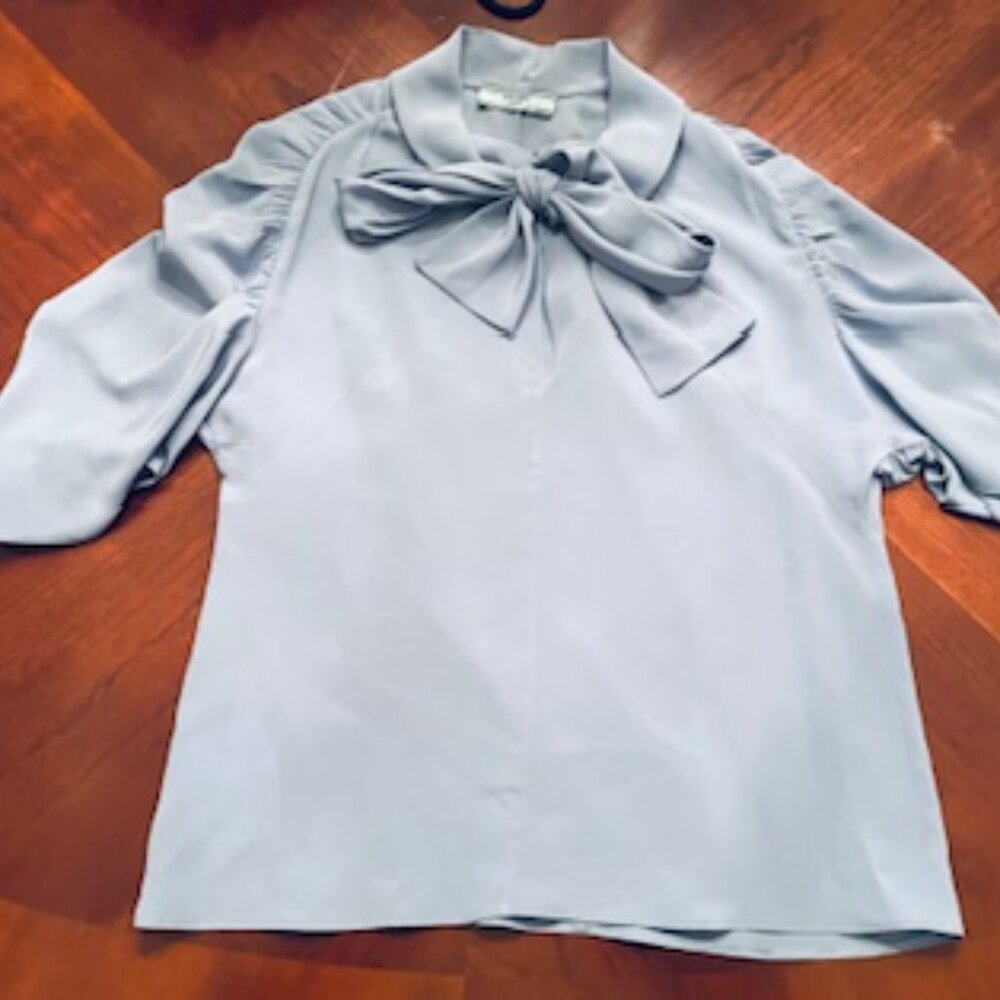 Prada: Baby Blue 100% Silk Blouse With Tie Neck Flutter Sleeve Size 38